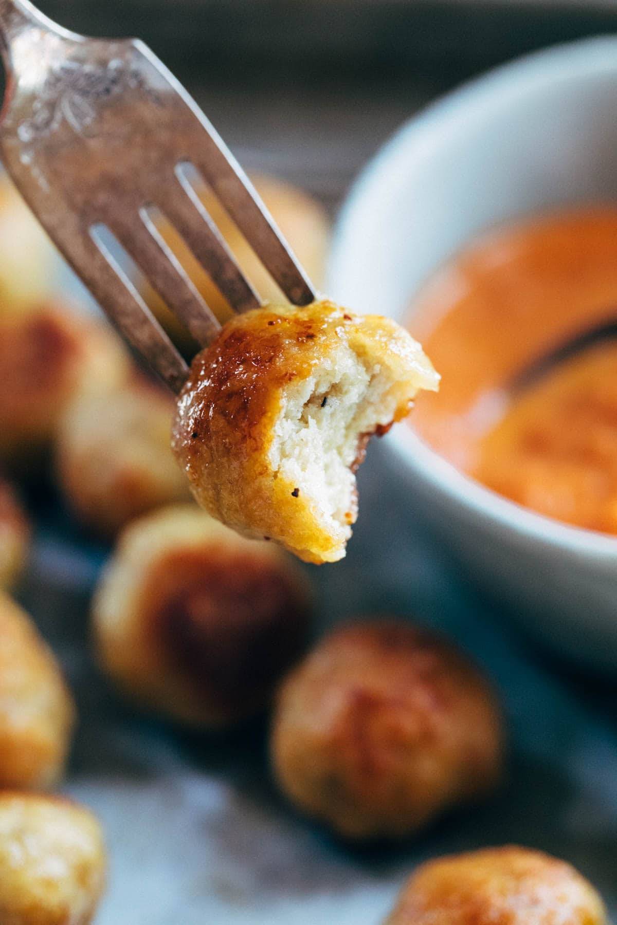 Baked Chicken Meatball with bite taken out.