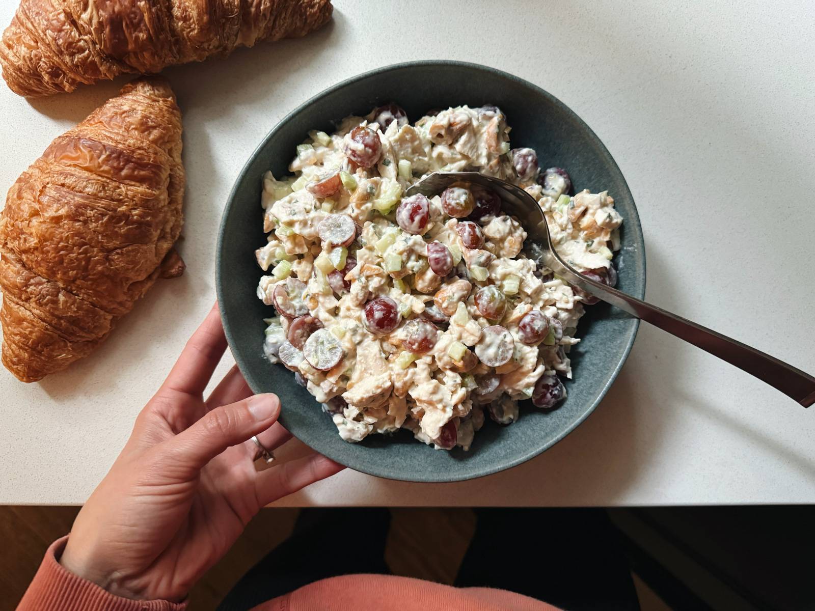 Chicken salad in a bowl with a spoon.