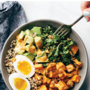 White hand with a fork digging into Chipotle Tahini Bowls