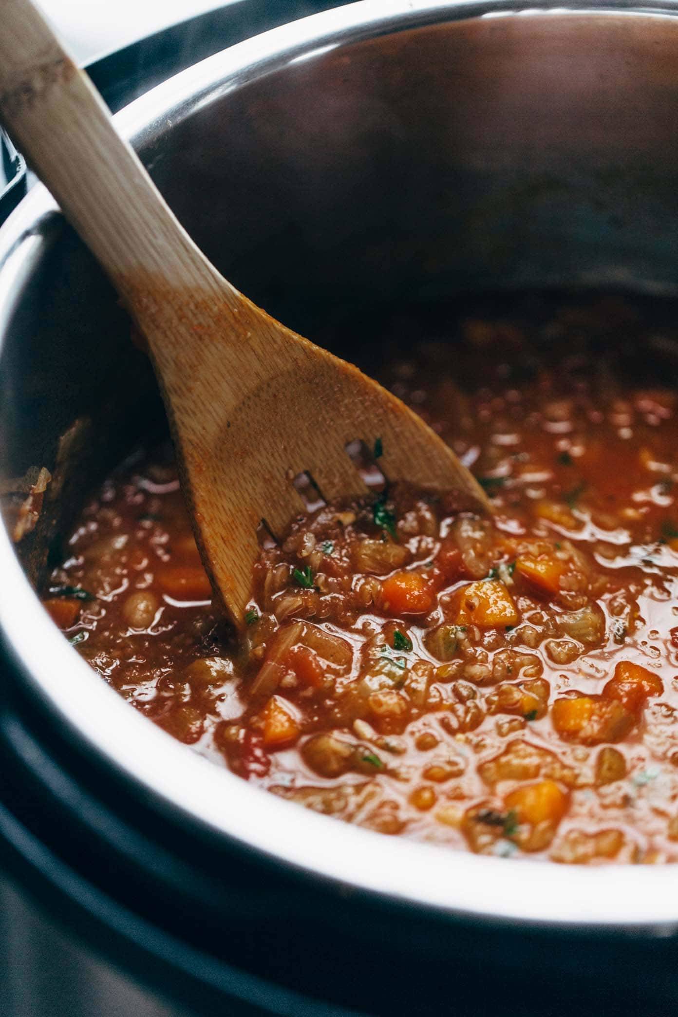 instant pot minestrone soup with a wooden spoon