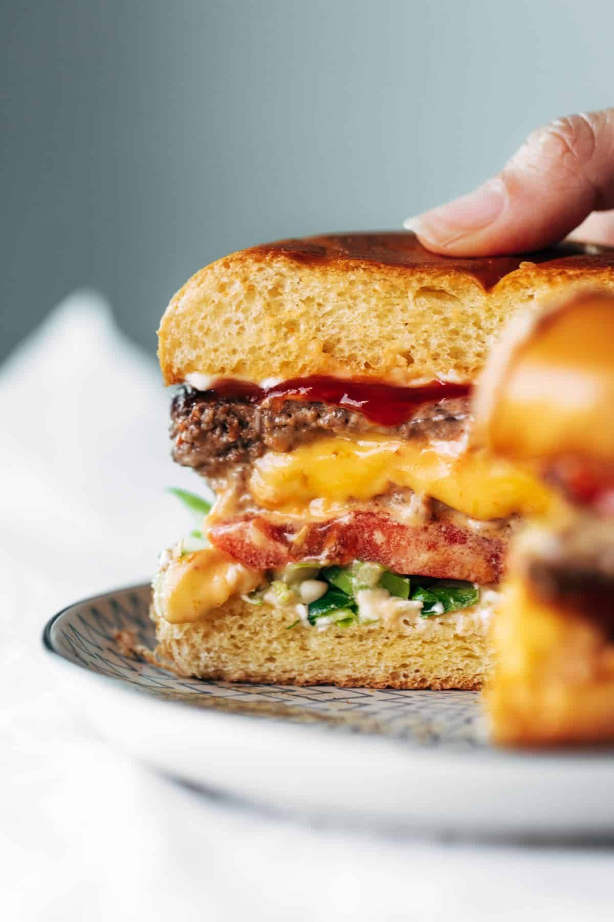 Juicy Lucy on plate cut in half.