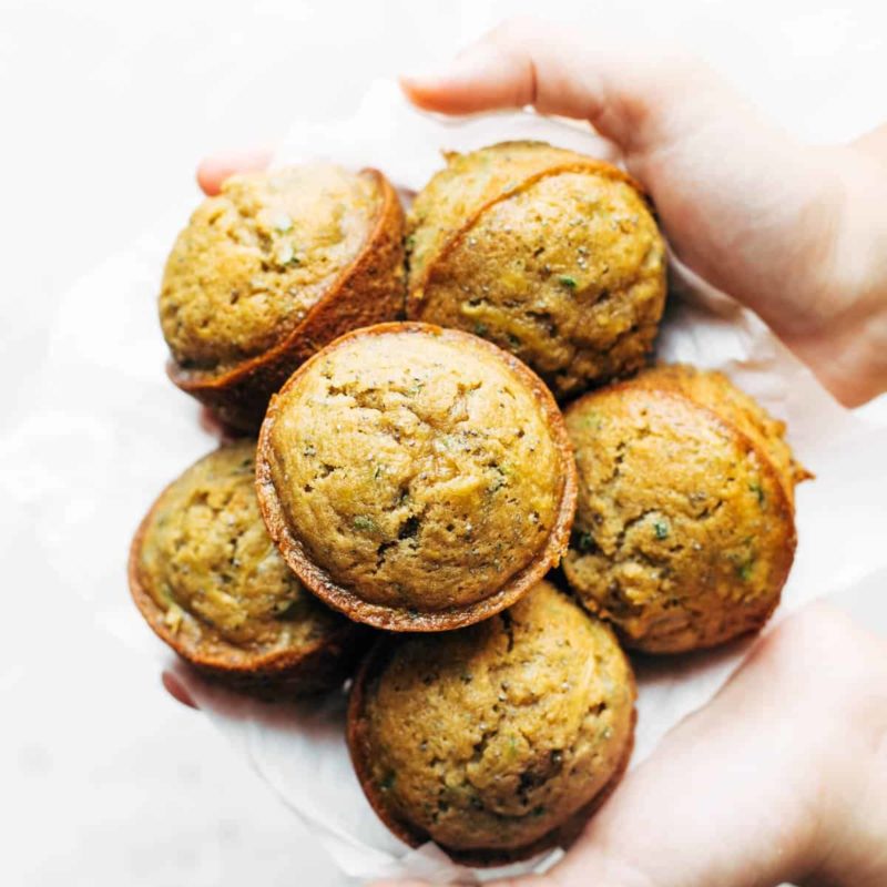 Lemon Zucchini Muffins held by hands.