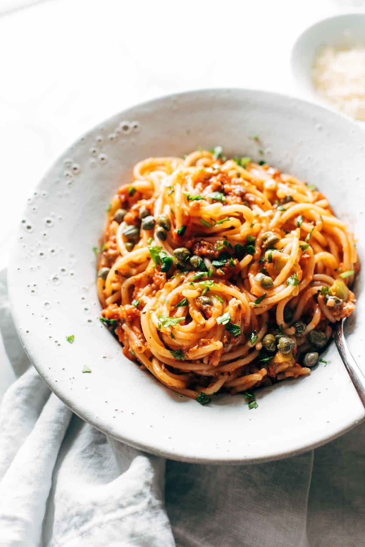 Roasted tomato puttanesca in a bowl.