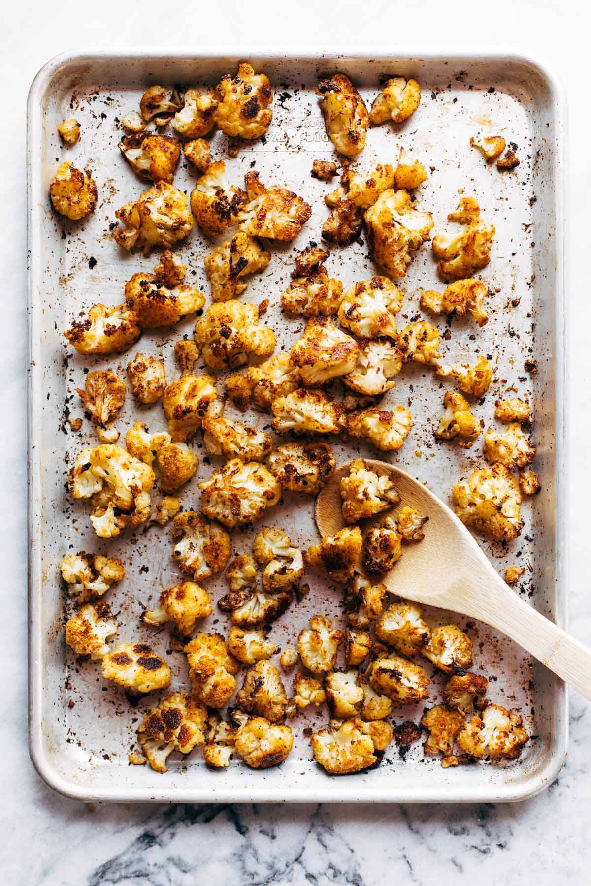 Roasted cauliflower on a sheet pan.