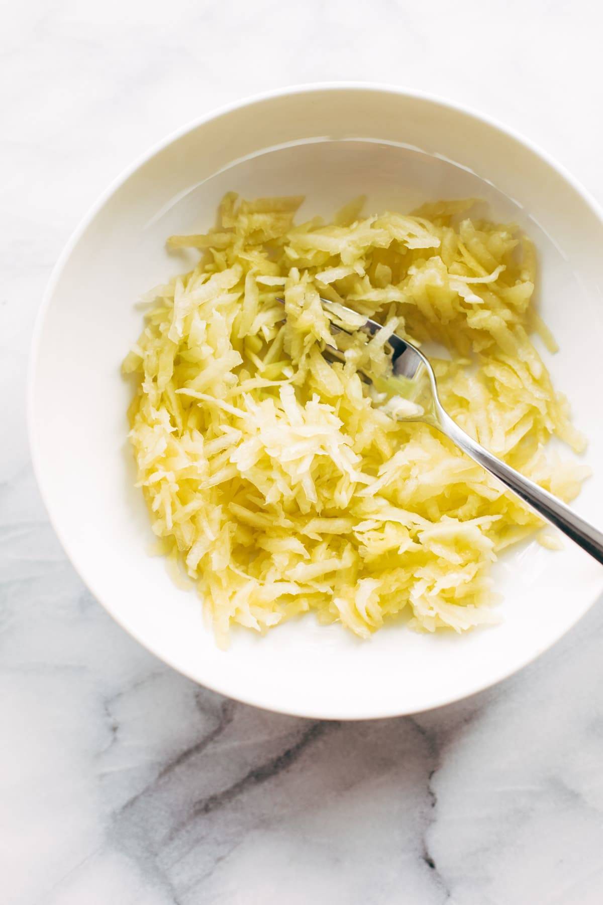 Thai Chicken Green Papaya Salad in a bowl with a spoon.